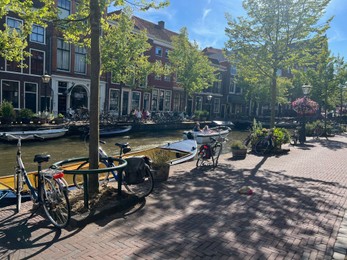 Photo of Leiden, Netherlands - August 03, 2022: View of city street with buildings along canal