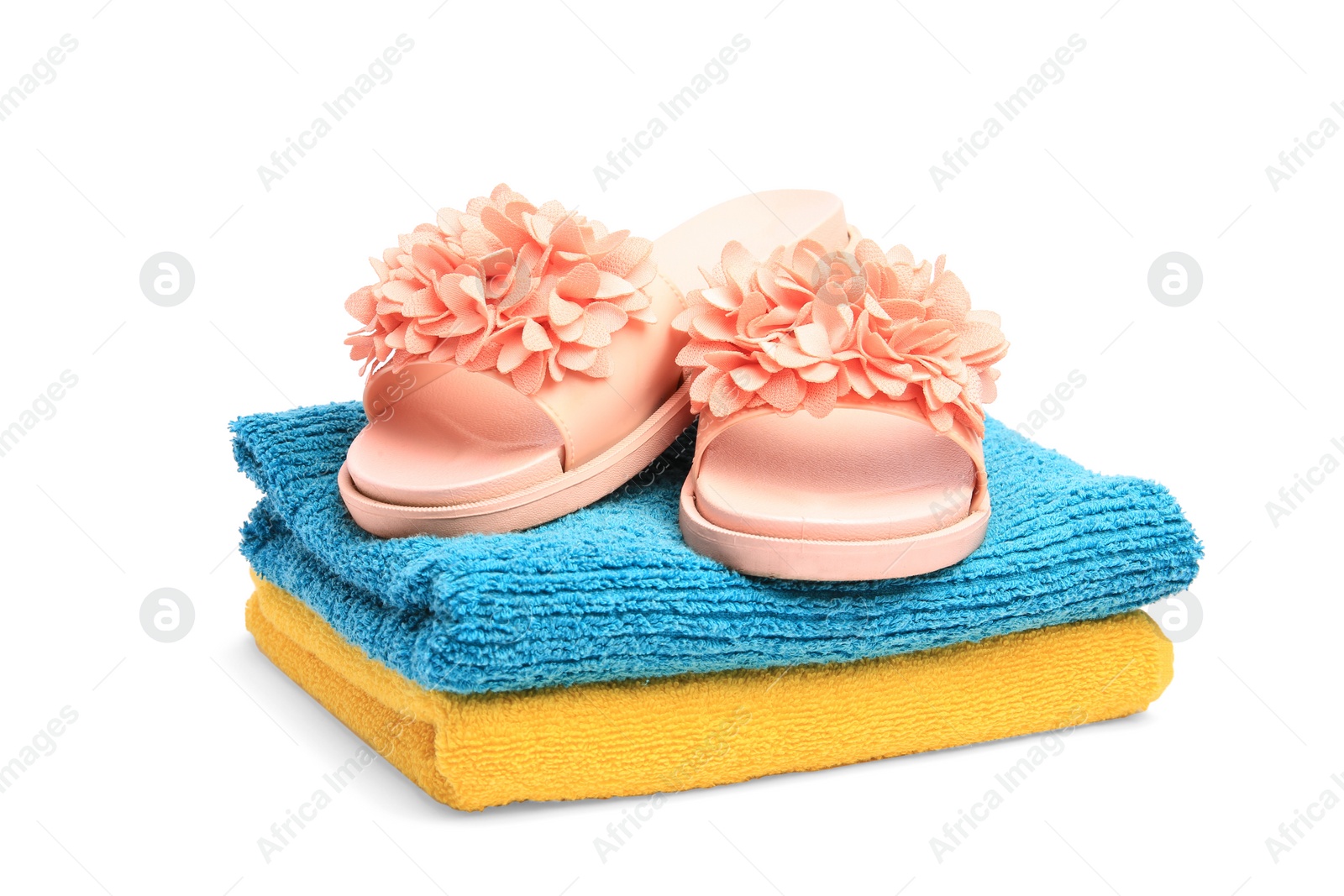 Photo of Colorful terry towels and flip flops isolated on white. Beach objects