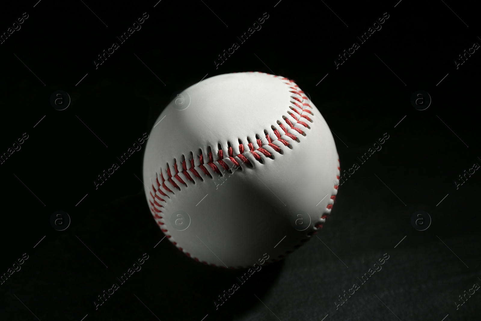 Photo of Baseball ball on black background, closeup. Sports game