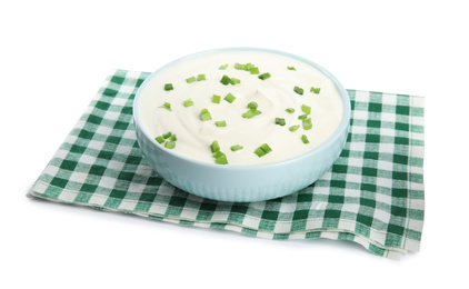 Photo of Fresh sour cream with onion and fabric on white background