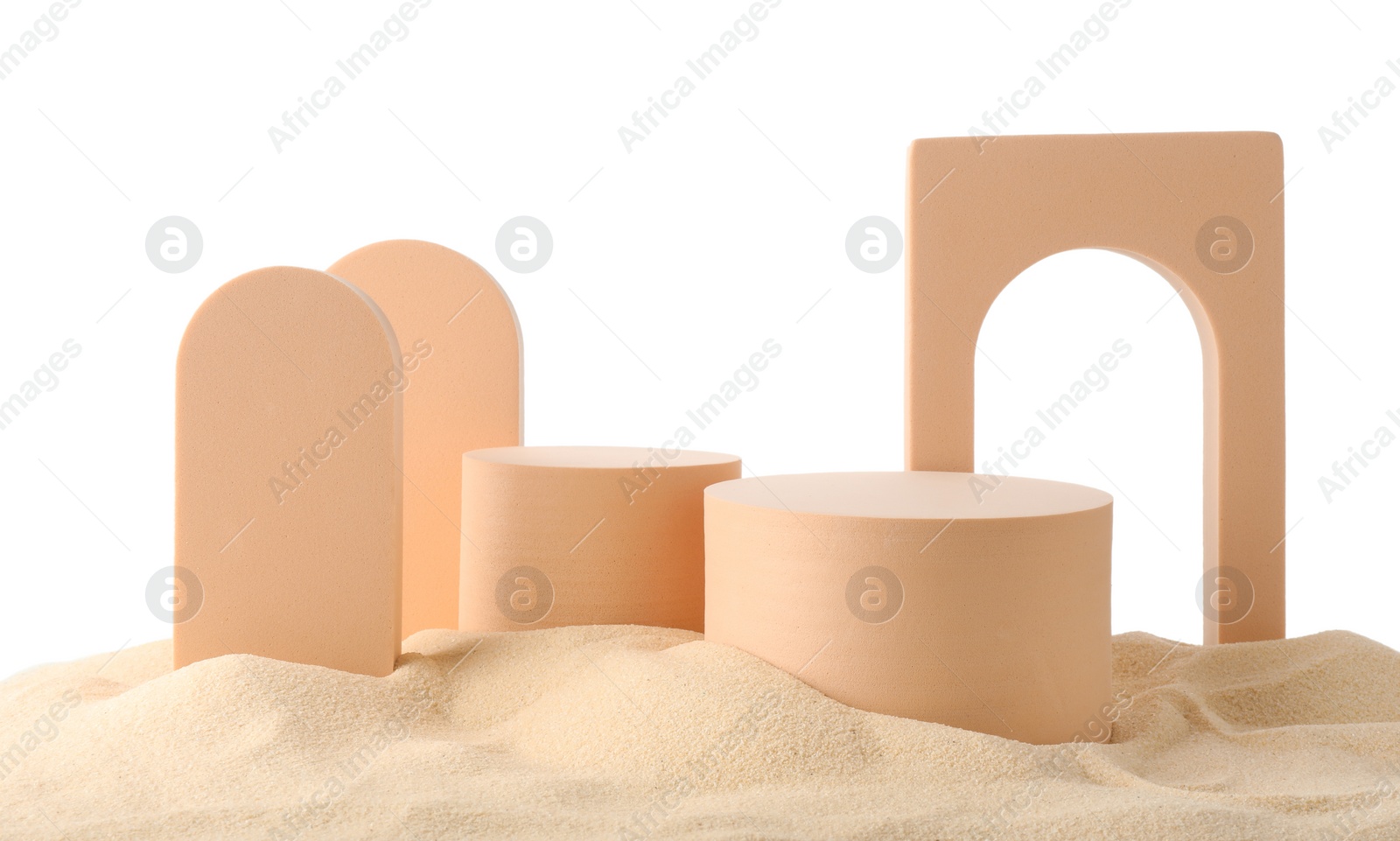 Photo of Presentation of product. Different podiums on sand against white background