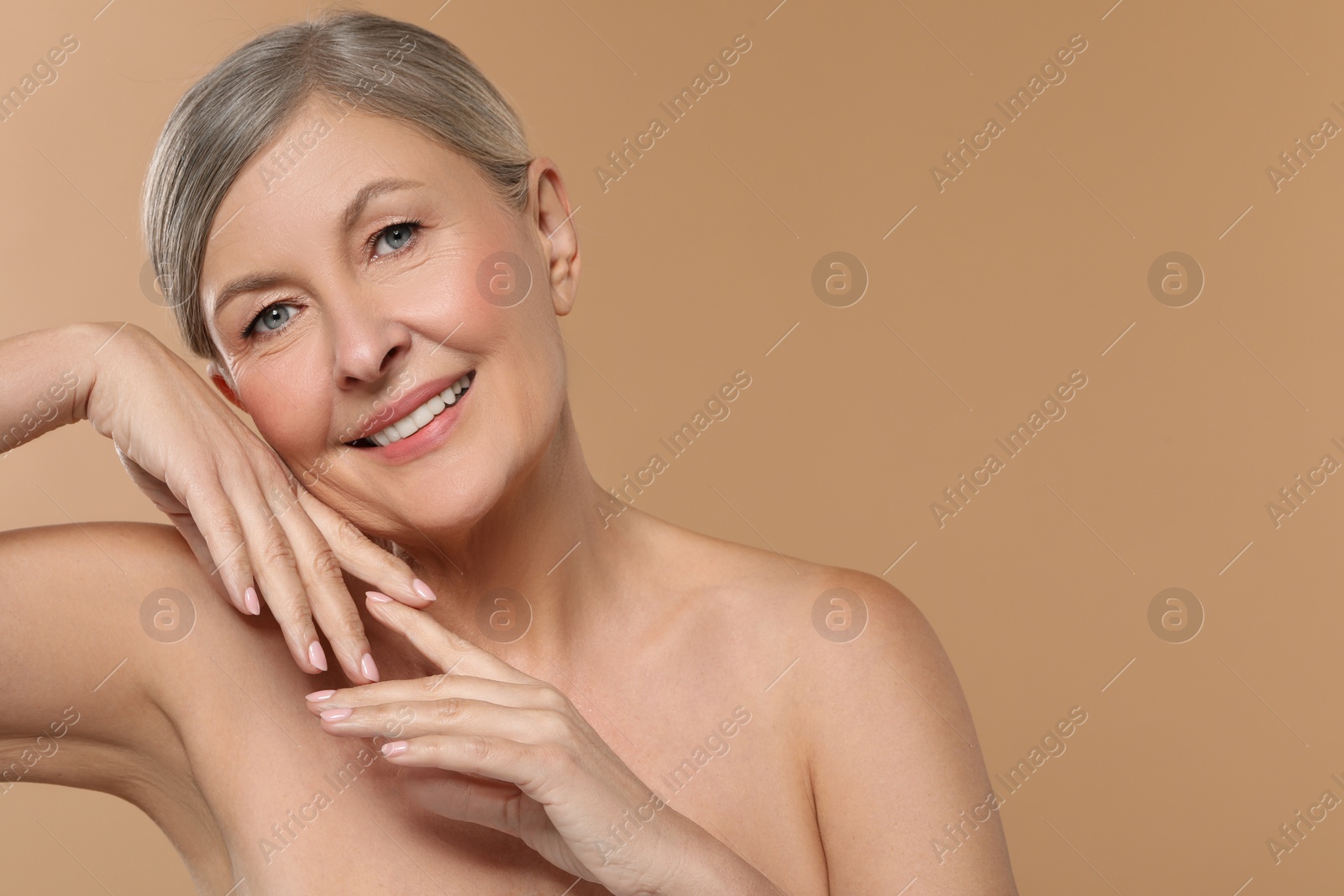 Photo of Beautiful mature woman with healthy skin on beige background, space for text