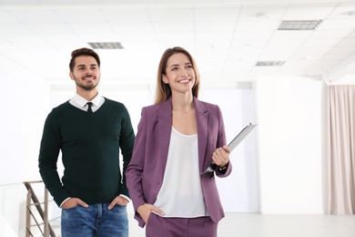 Photo of Real estate agent with client in new apartment. Space for text