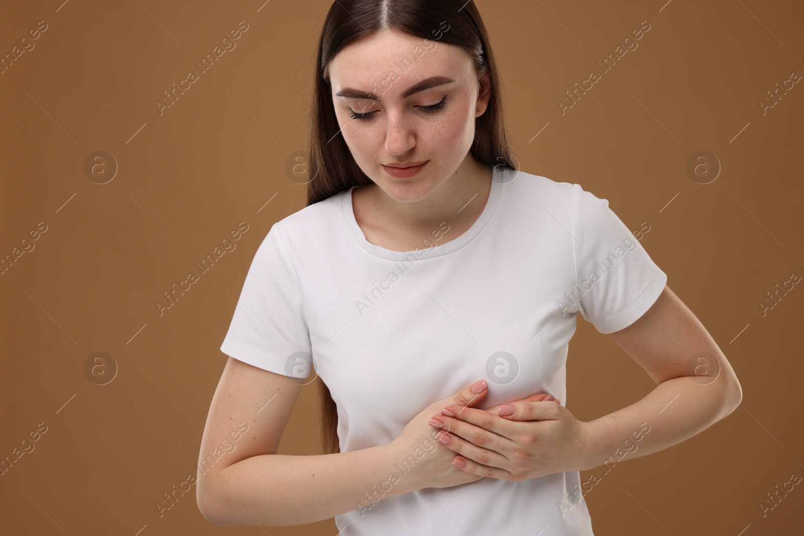 Photo of Woman having heart attack on brown background