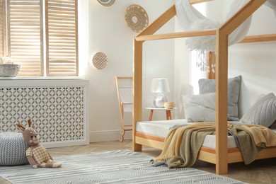 Photo of Stylish child room interior with house bed