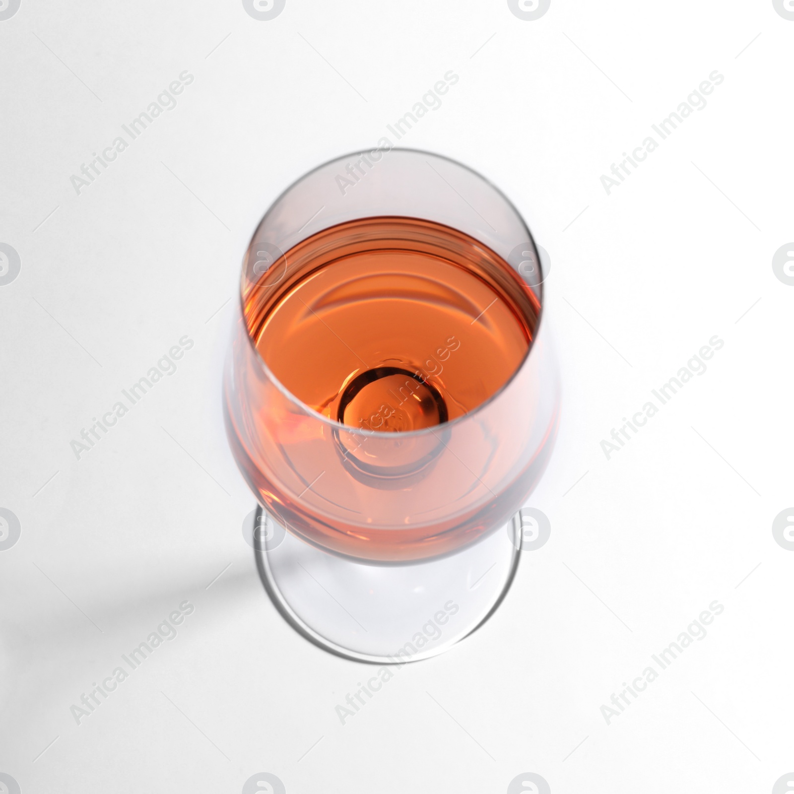 Photo of Glass of delicious wine on white background, above view
