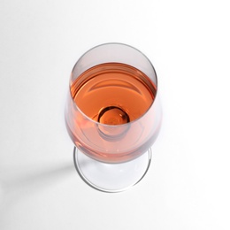 Glass of delicious wine on white background, above view