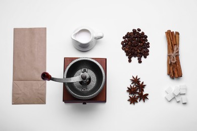 Flat lay composition with vintage manual coffee grinder on white background
