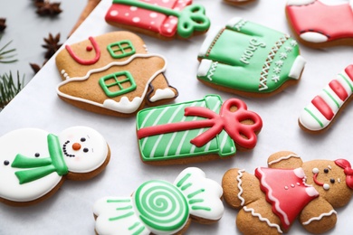Photo of Delicious homemade Christmas cookies on baking paper