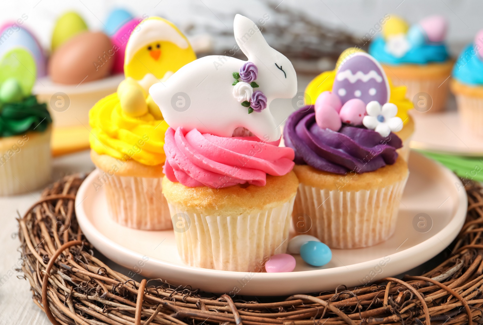 Photo of Tasty decorated Easter cupcakes on table, closeup