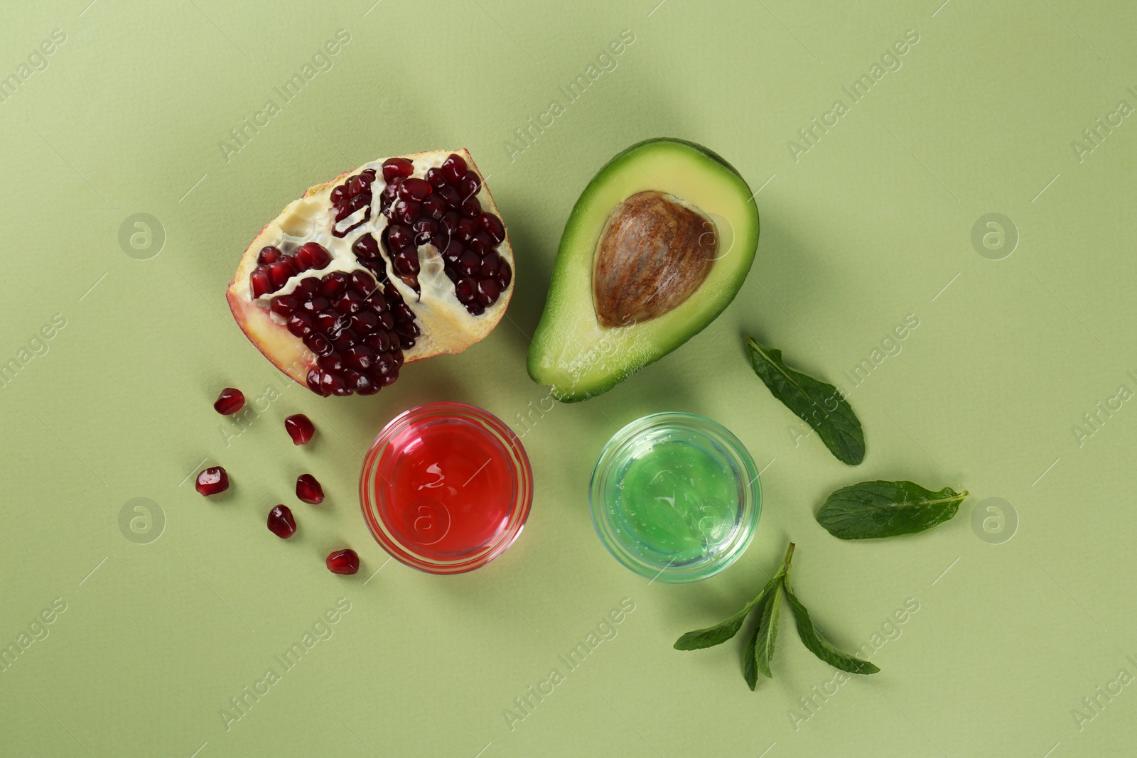 Photo of Flat lay composition with homemade cosmetic products and fresh ingredients on light green background. DIY beauty recipe