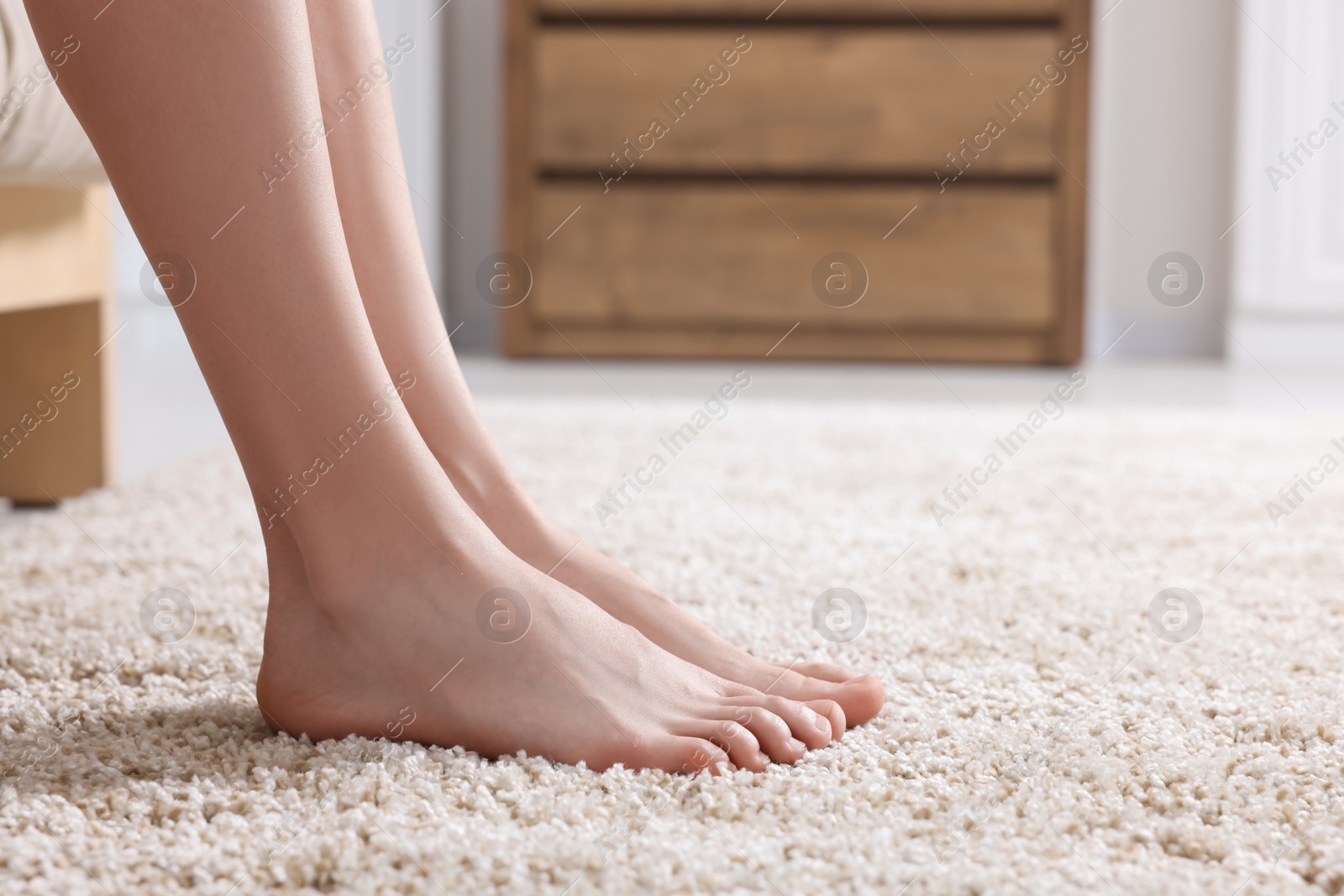 Photo of Woman on soft light brown carpet at home, closeup. Space for text