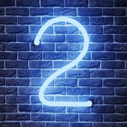 Image of Glowing neon number 2 sign on brick wall