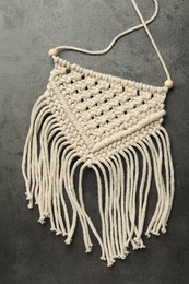 Photo of Stylish beige macrame on grey table, top view