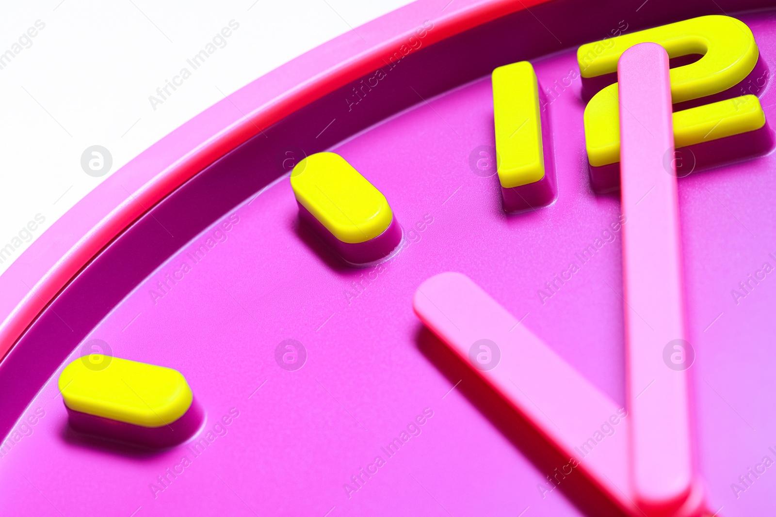 Photo of Stylish round clock on white background, closeup. Interior element