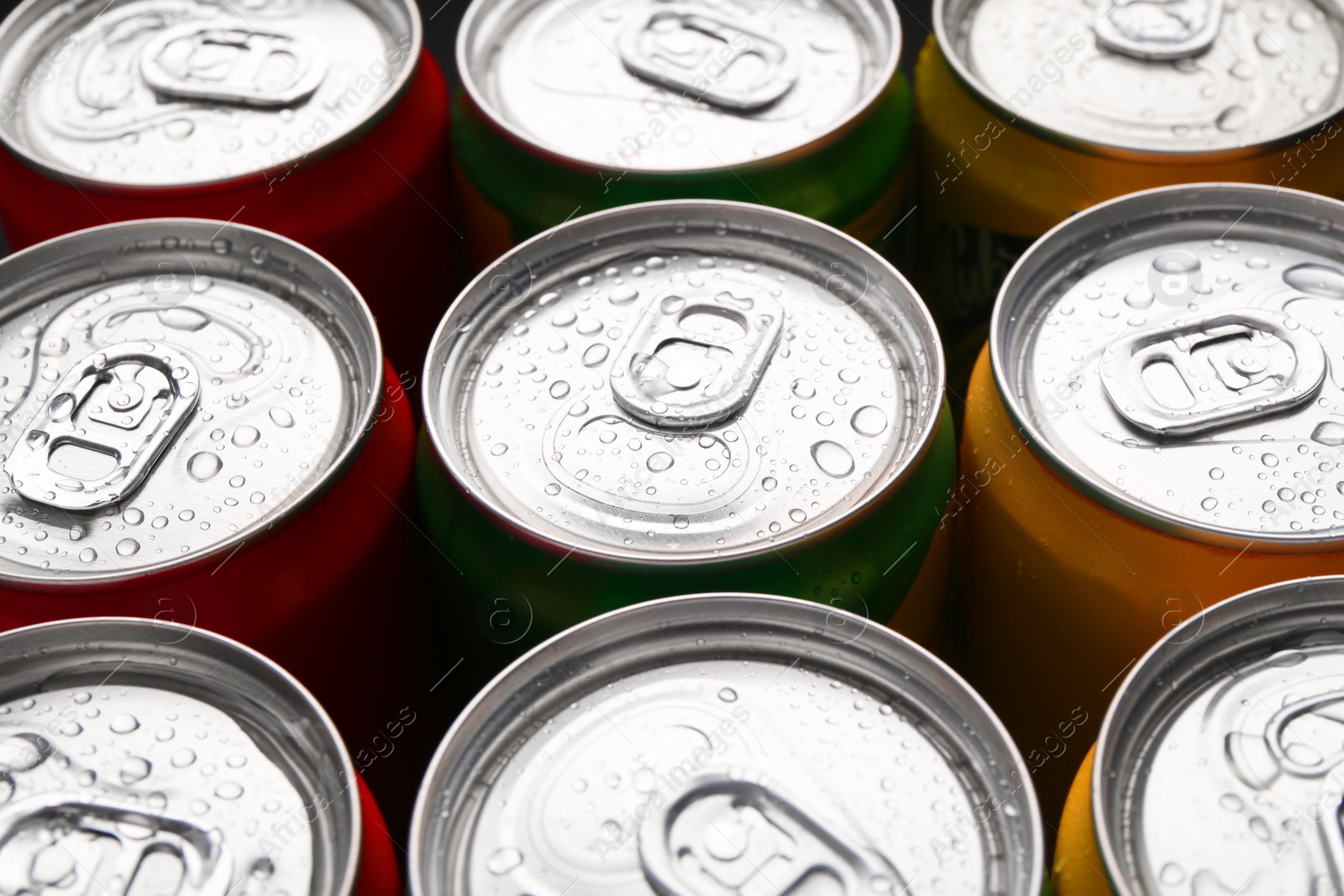 Photo of Energy drinks in wet cans, closeup. Functional beverage