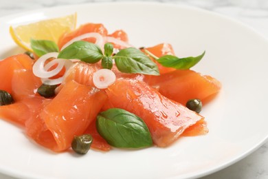 Photo of Delicious salmon carpaccio served on table, closeup