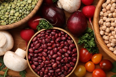 Photo of Different vegetables on wooden table, flat lay. Vegan diet