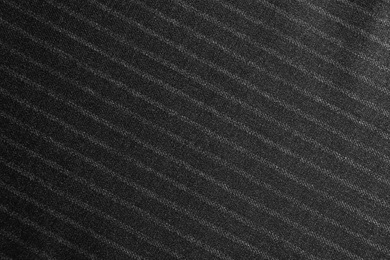 Photo of Texture of dark striped fabric as background, closeup