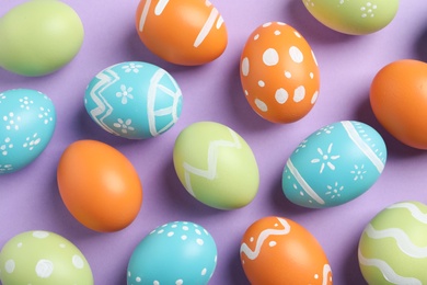 Photo of Many beautiful painted Easter eggs on color background, top view