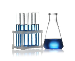 Test tubes in rack and conical flask with liquid samples on white background. Chemistry glassware