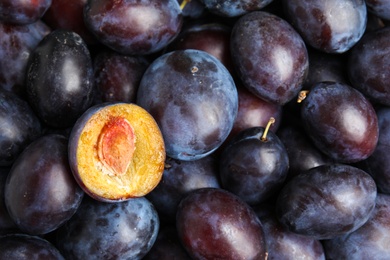 Photo of Many delicious ripe plums as background, closeup