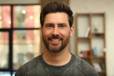 Photo of Portrait of handsome stylish man in office