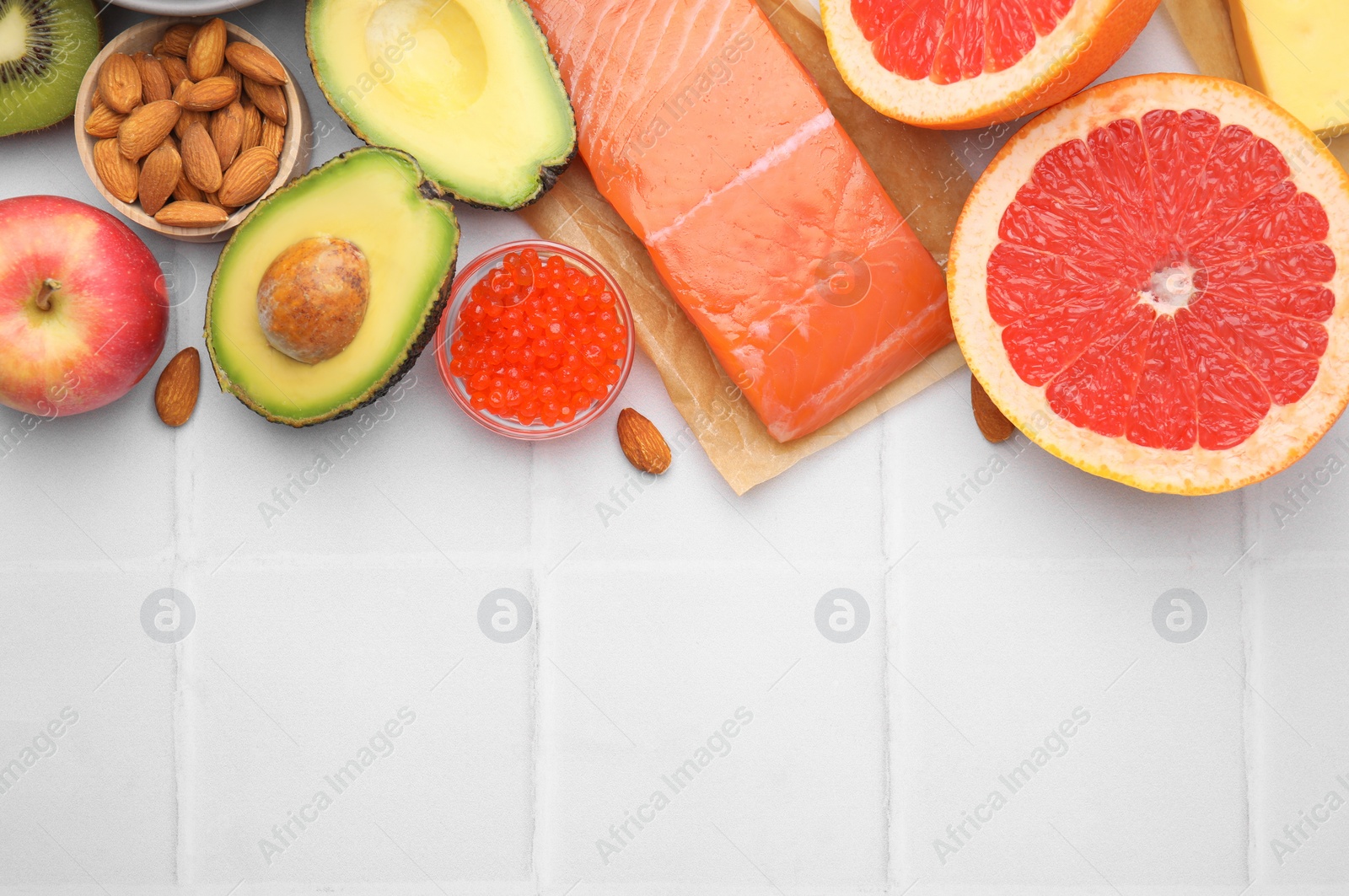 Photo of Many different products on white tiled table, flat lay and space for text. Natural sources of serotonin