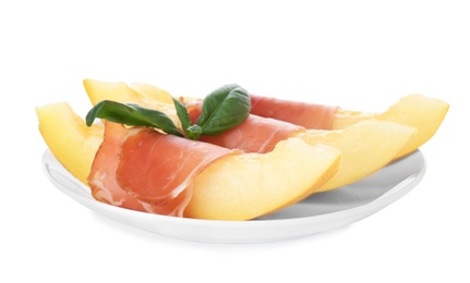 Plate with melon slices and prosciutto on white background