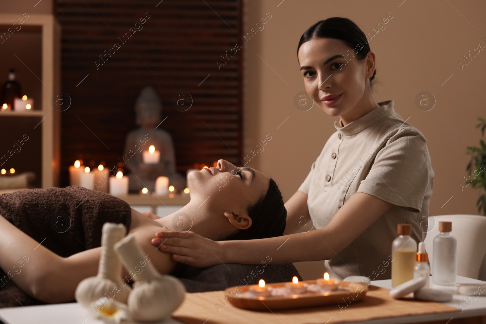 Photo of Spa therapy. Beautiful young woman lying on table during massage in salon