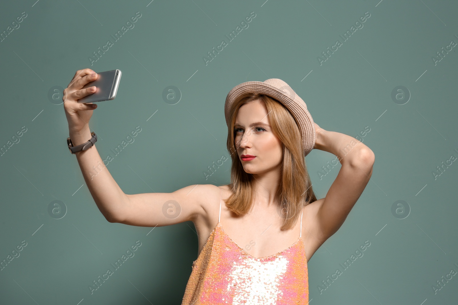 Photo of Attractive young woman taking selfie on color background