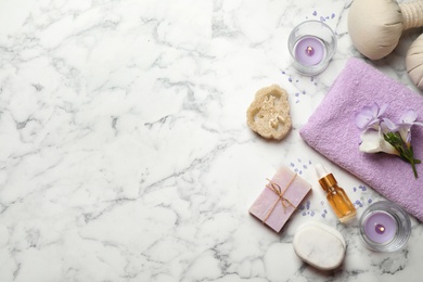 Photo of Flat lay spa composition with skin care products on white marble table, space for text