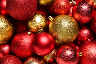 Red and golden Christmas balls as background, top view