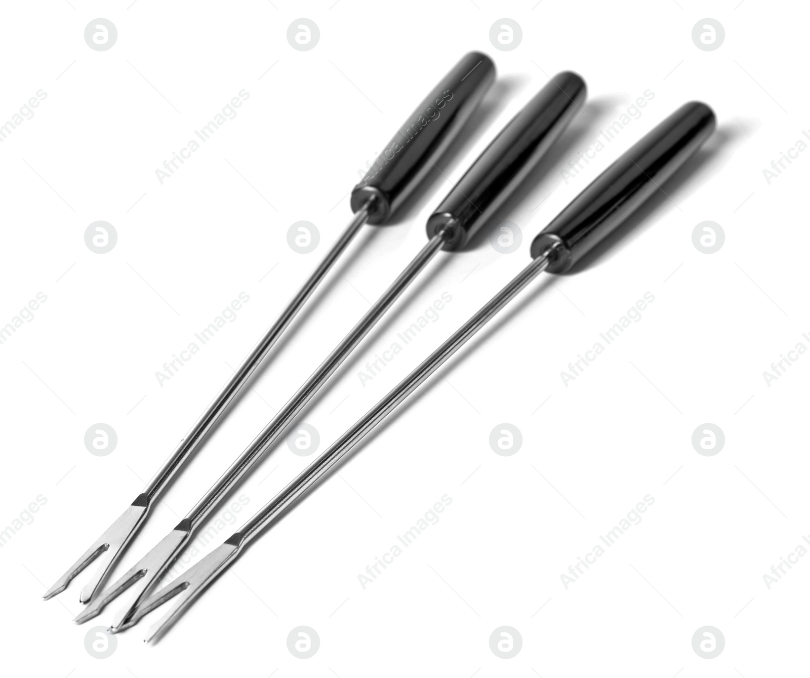 Photo of Set of fondue forks on white background. Kitchen equipment