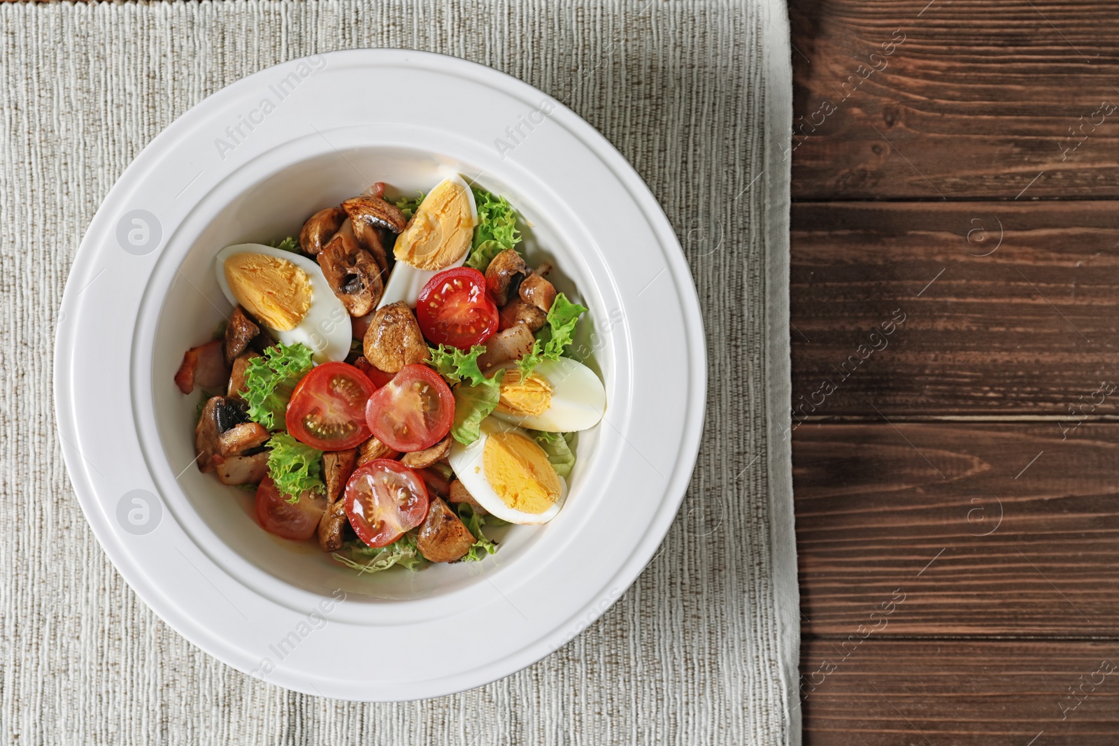 Photo of Plate with delicious fresh salad on table, top view