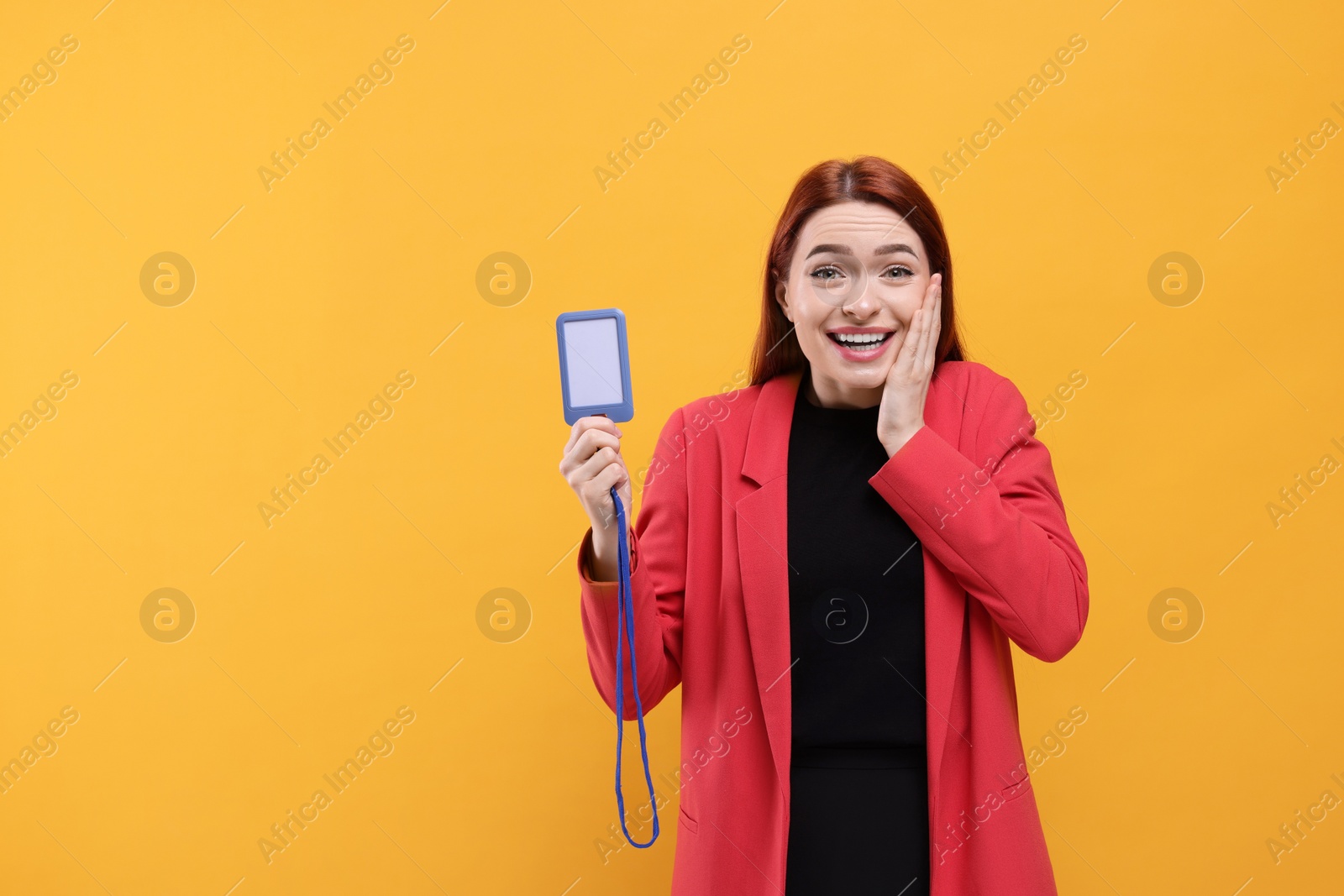 Photo of Emotional woman with vip pass badge on orange background. Space for text