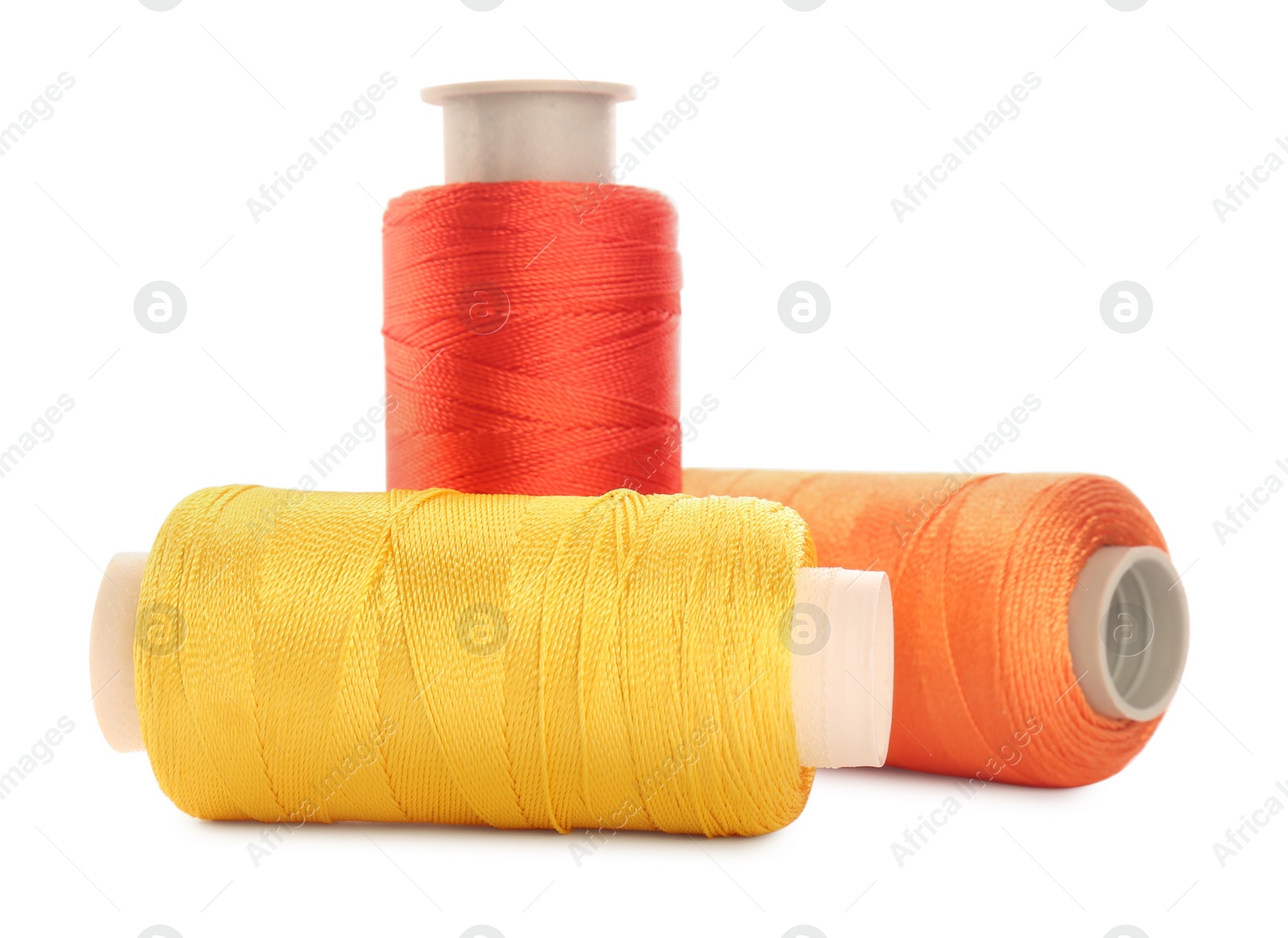 Photo of Different colorful sewing threads on white background