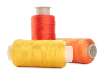 Photo of Different colorful sewing threads on white background