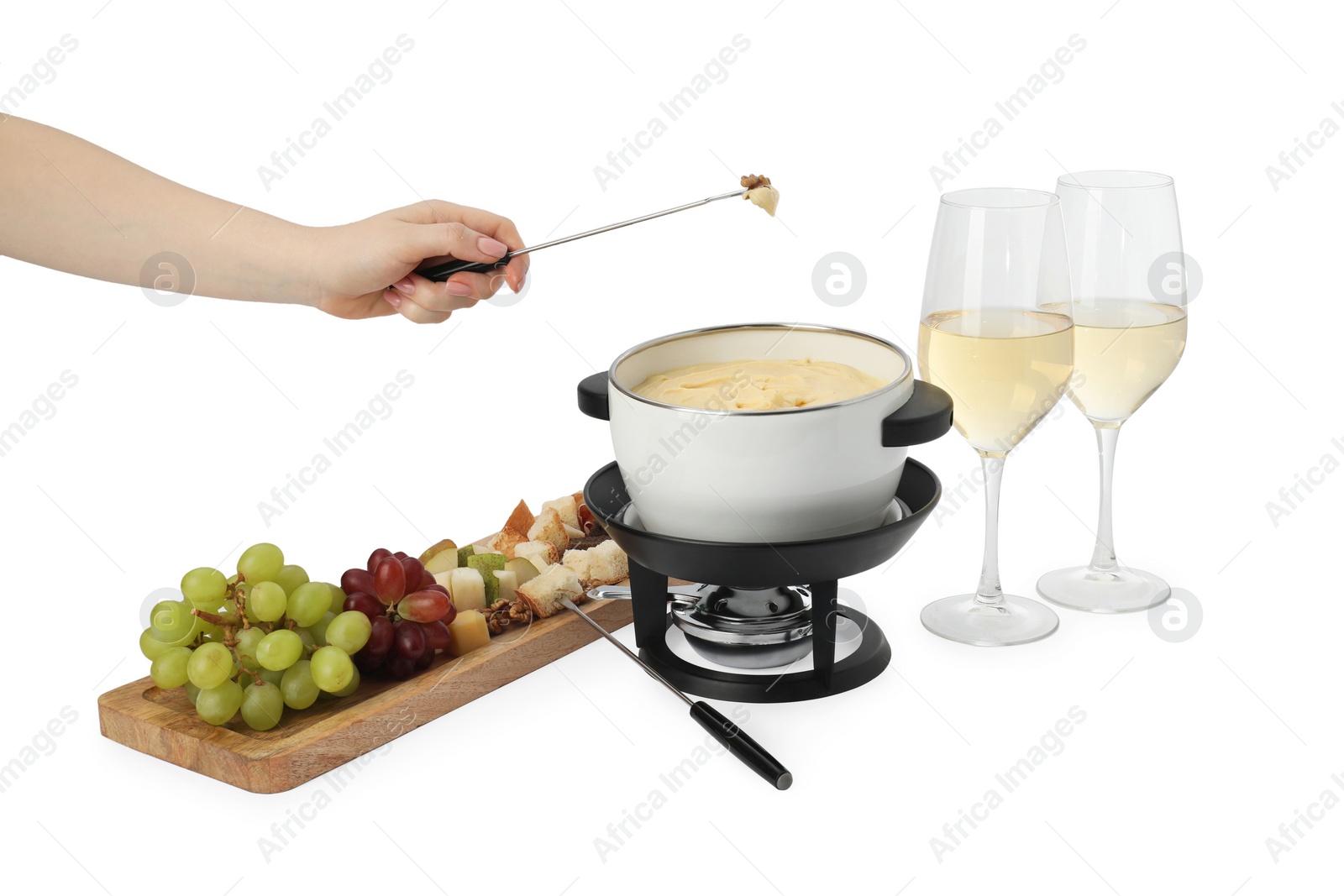 Photo of Woman dipping walnut into fondue pot with melted cheese on white background, closeup