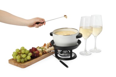 Woman dipping walnut into fondue pot with melted cheese on white background, closeup