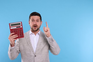 Emotional accountant with calculator on light blue background. Space for text