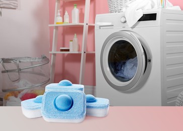 Image of  water softener tablets and modern washing machine in laundry room