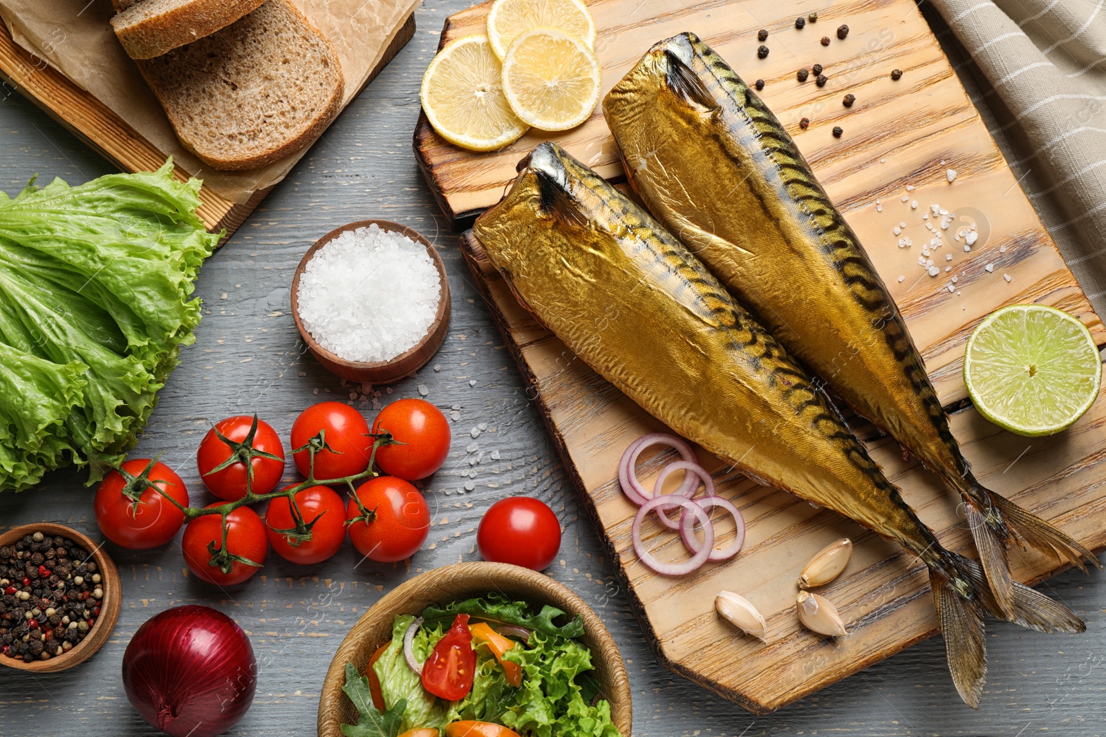 Photo of Flat lay composition with tasty smoked fish on wooden table