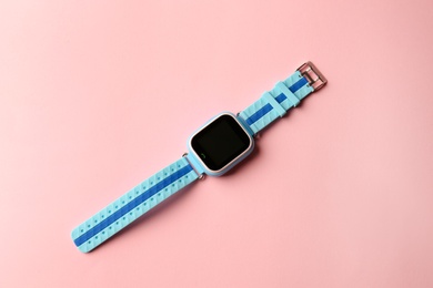 Photo of Trendy smart watch for kids on pink background, top view
