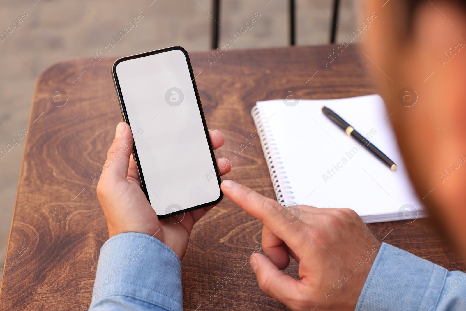 Photo of Man using mobile phone at table, closeup. Space for text