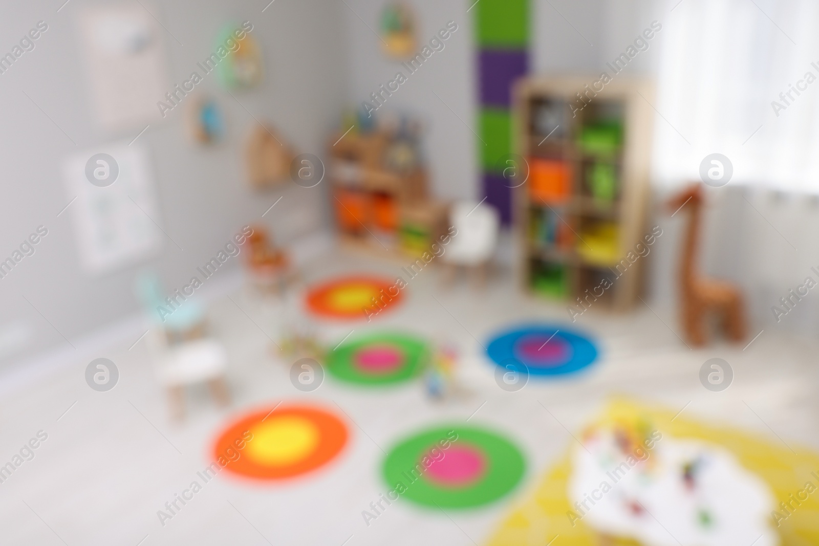 Photo of Blurred view of child`s playroom. Kindergarten interior