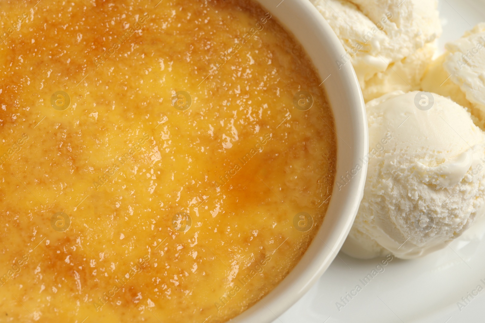 Photo of Delicious creme brulee and scoops of ice cream on plate, closeup