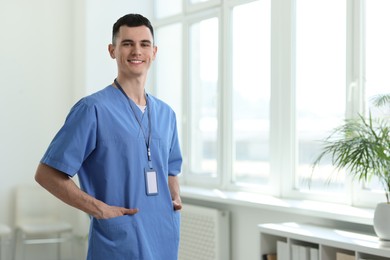 Photo of Portrait of smiling medical assistant in hospital. Space for text