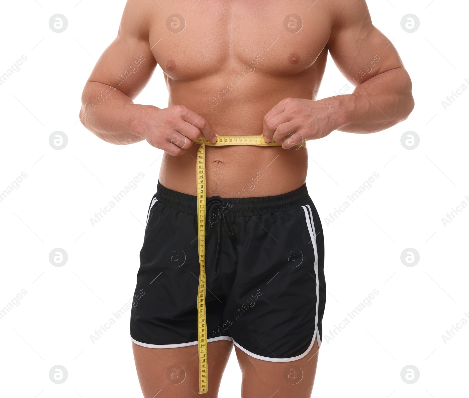 Photo of Athletic man measuring waist with tape on white background, closeup. Weight loss concept