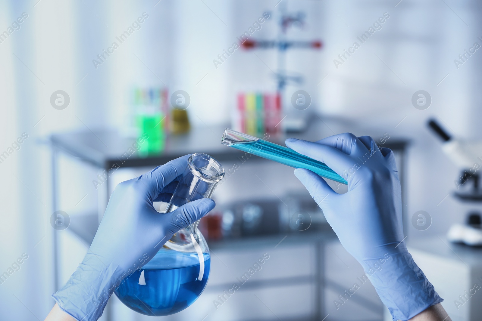 Photo of Scientist doing analysis in lab, closeup. Solution chemistry